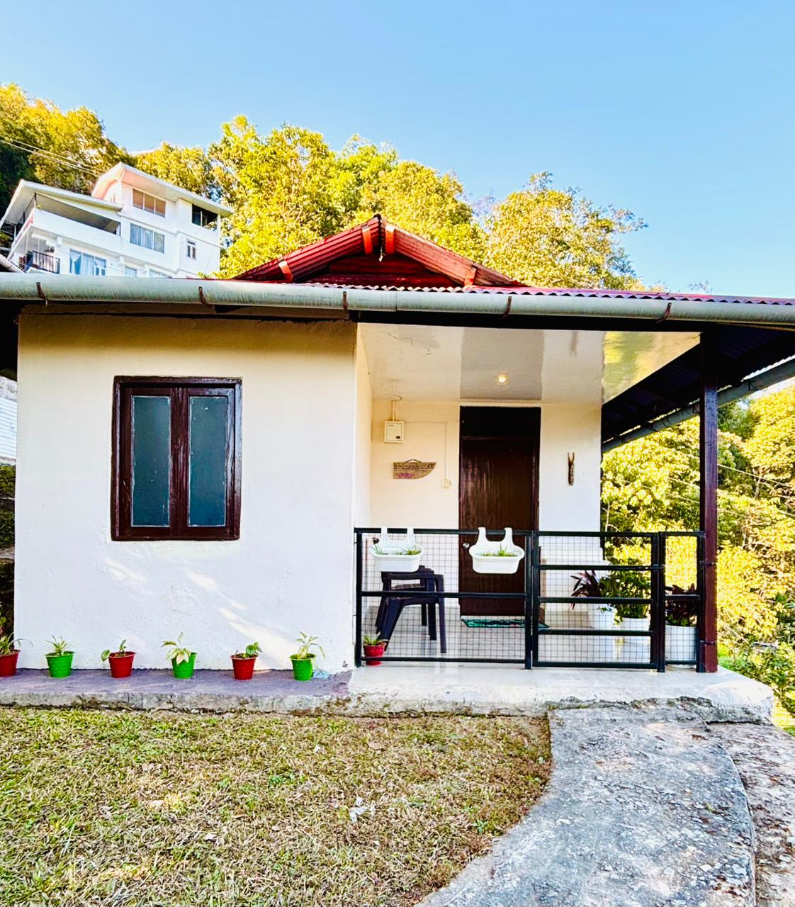 Private cottage with veranda and potted plants at Arosia By Mustard Seed