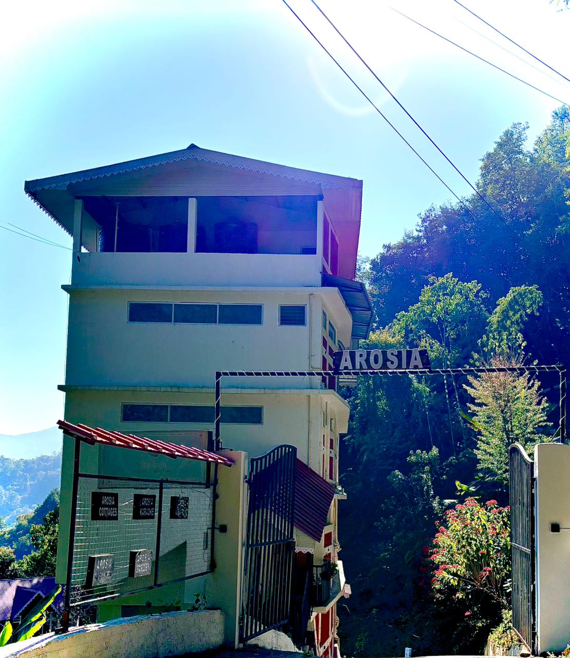 Arosia entrance gate and main building on the hillside in Rumtek