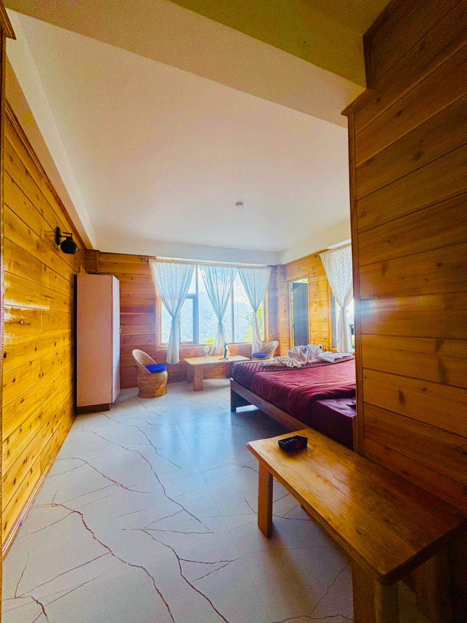 King Suite interior with timber walls, seating and marble flooring