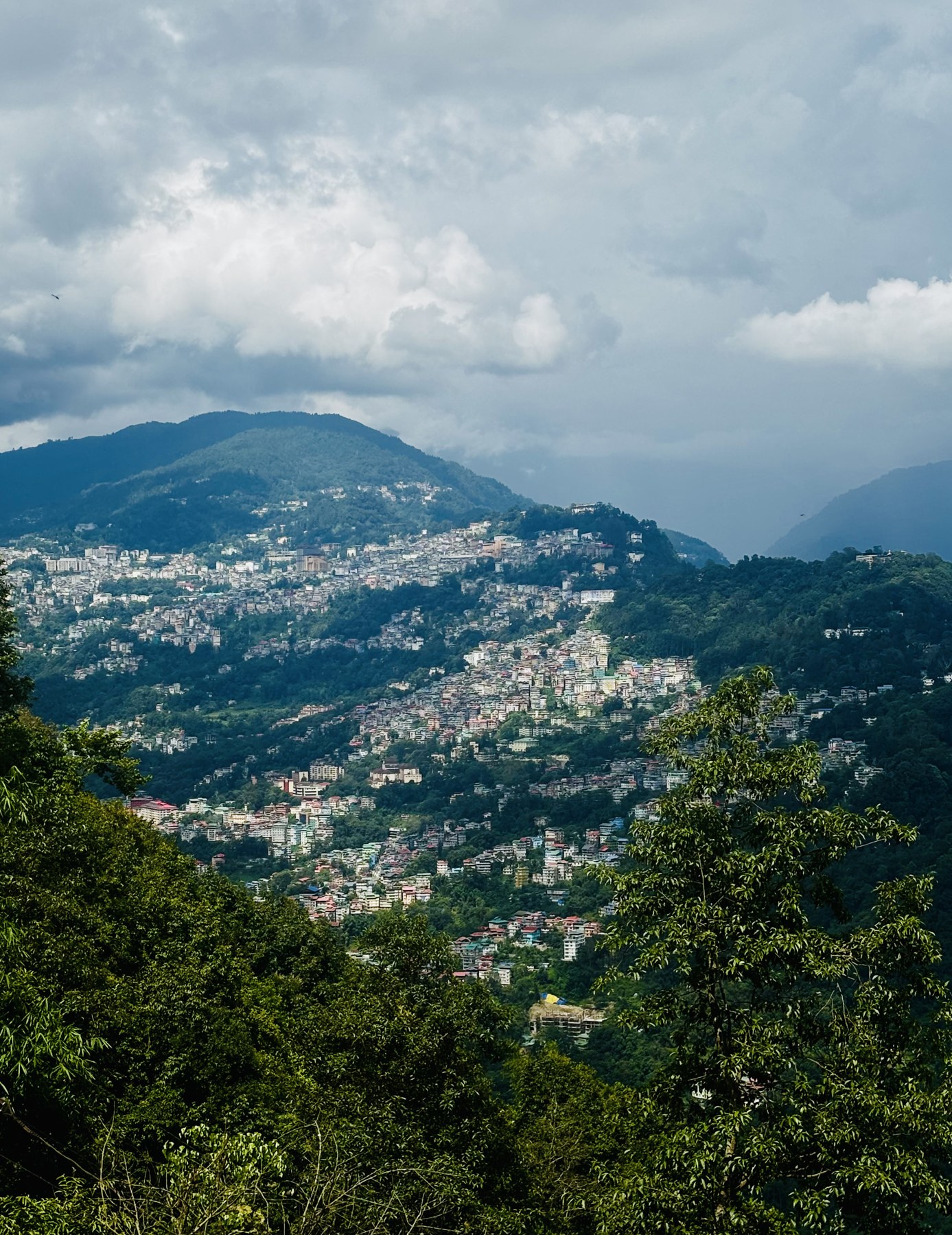 View from Arosia By Mustard Seed of the hillside town across the ranges